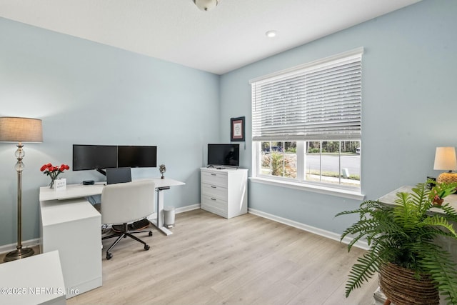 office featuring baseboards and light wood finished floors