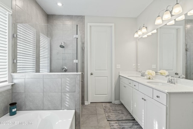 full bathroom with tile patterned floors, a sink, a shower stall, double vanity, and a bath