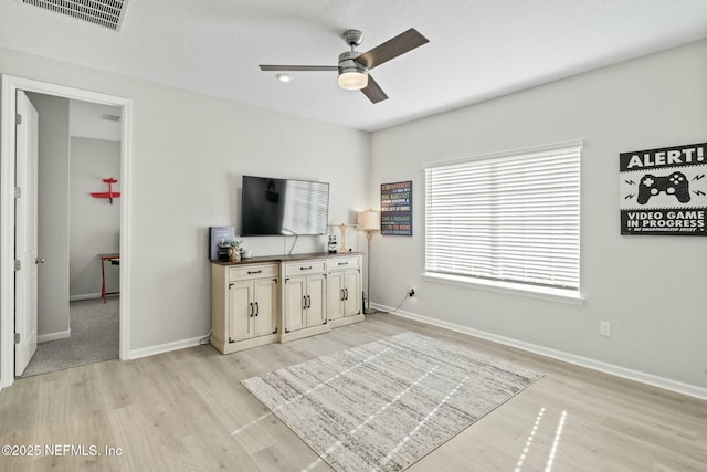 bedroom with visible vents, light wood-style flooring, baseboards, and ceiling fan