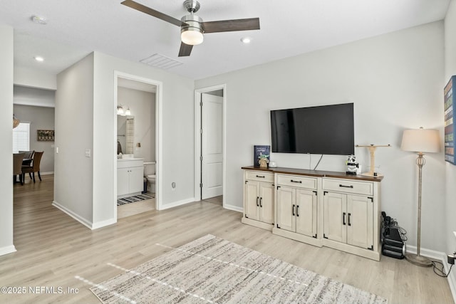 unfurnished living room with baseboards, light wood-style floors, visible vents, and ceiling fan