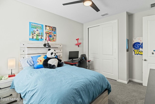 carpeted bedroom featuring visible vents, baseboards, a closet, and a ceiling fan