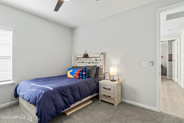 bedroom with ceiling fan, baseboards, visible vents, and light carpet