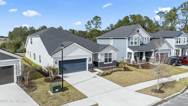 view of front facade featuring a front lawn, concrete driveway, roof with shingles, stone siding, and an attached garage