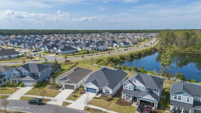 drone / aerial view with a residential view and a water view