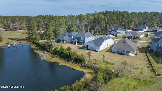 birds eye view of property with a view of trees, a residential view, and a water view