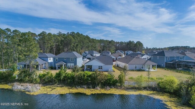 birds eye view of property with a residential view and a water view