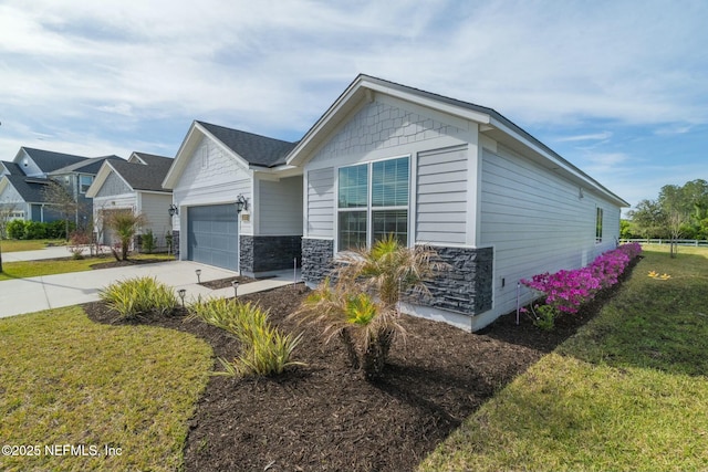 view of front of house featuring stone siding, driveway, an attached garage, and a front yard