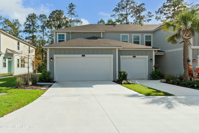 view of front of property featuring concrete driveway, a garage, board and batten siding, and a shingled roof