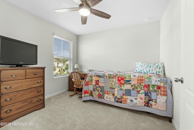 carpeted bedroom featuring baseboards and a ceiling fan