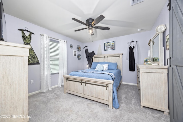 bedroom featuring visible vents, light colored carpet, baseboards, and ceiling fan