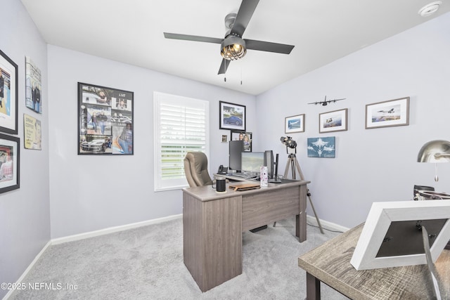 home office with ceiling fan, baseboards, and light carpet