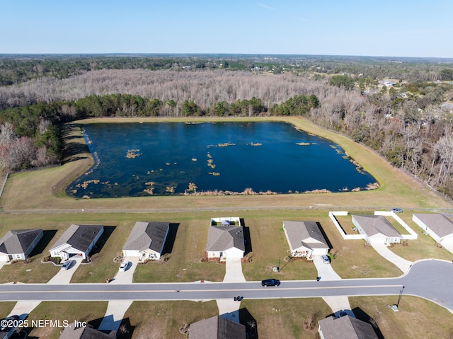 birds eye view of property featuring a view of trees and a water view