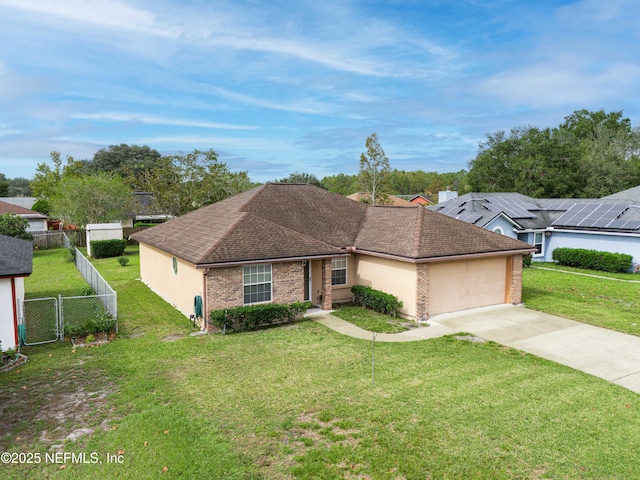 ranch-style home featuring a front lawn, fence, concrete driveway, an attached garage, and brick siding