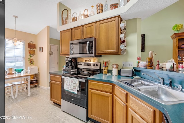 kitchen featuring a chandelier, decorative light fixtures, appliances with stainless steel finishes, light tile patterned flooring, and a sink