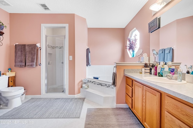 bathroom with tile patterned floors, visible vents, a shower stall, and vanity