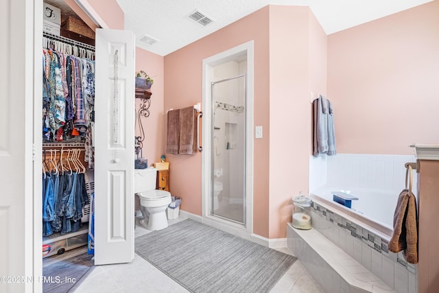 full bath with tile patterned flooring, a spacious closet, toilet, and visible vents