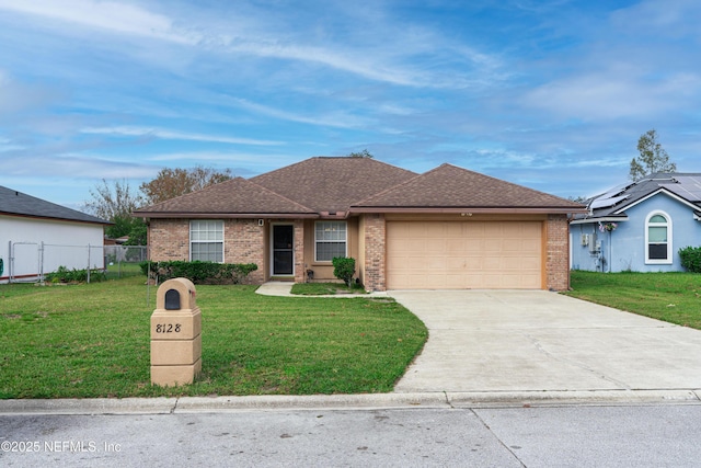 ranch-style home featuring brick siding, a garage, concrete driveway, and a front lawn