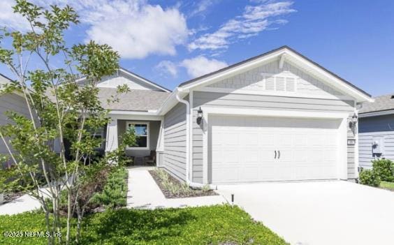 ranch-style home with a garage and driveway