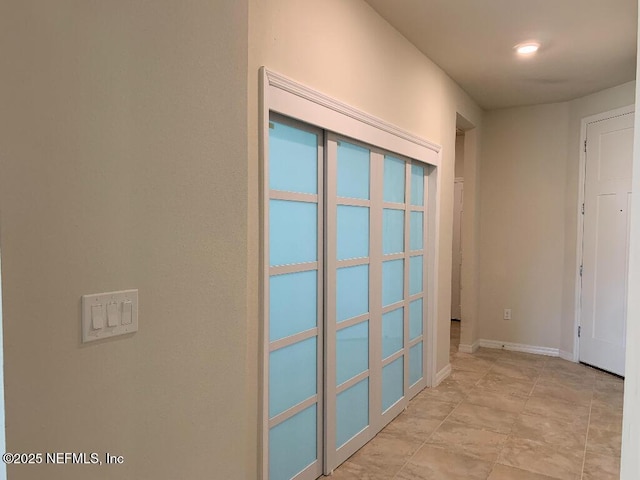 hallway featuring baseboards