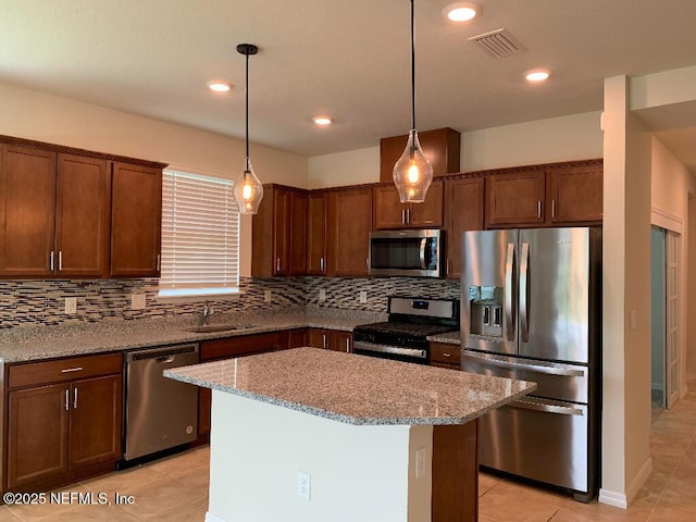 kitchen with visible vents, light stone counters, tasteful backsplash, stainless steel appliances, and light tile patterned floors