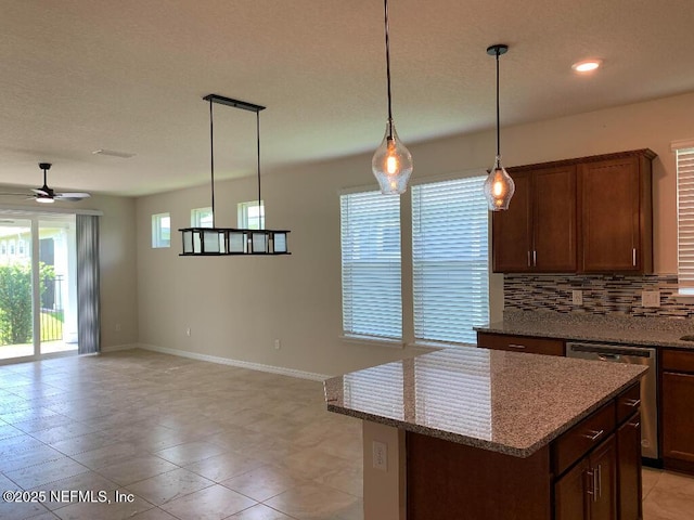 kitchen with backsplash, a kitchen island, open floor plan, dishwasher, and a ceiling fan