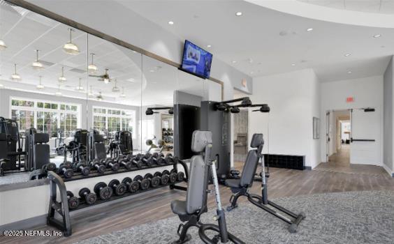 workout area with recessed lighting and wood finished floors