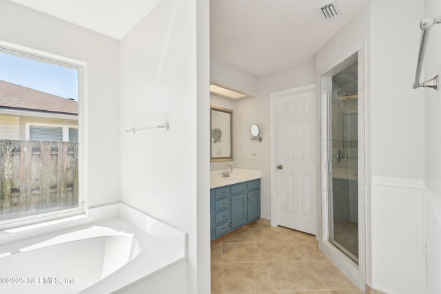 bathroom with tile patterned flooring, visible vents, a shower stall, a bath, and vanity