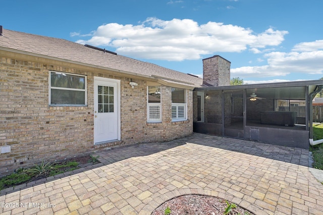 view of patio featuring a sunroom