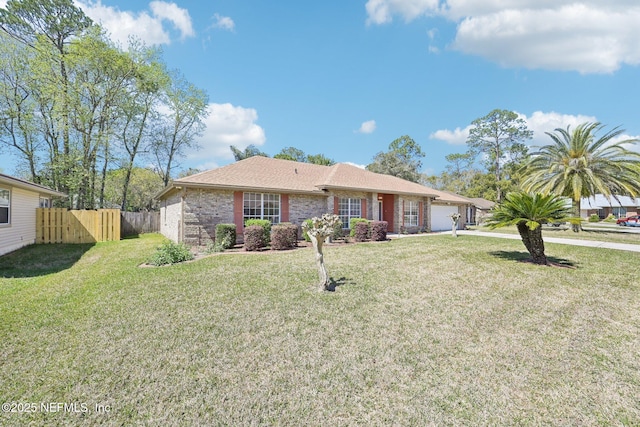 ranch-style home featuring brick siding, a front yard, and fence