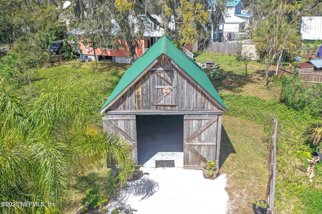 31 Lewis Blvd, Saint Augustine, FL 32084 - view of outbuilding featuring a garage, an outdoor structure, and fence