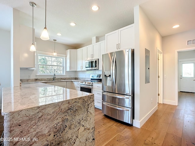 31 Lewis Blvd, Saint Augustine, FL 32084 - kitchen featuring light stone countertops, electric panel, stainless steel appliances, white cabinetry, and a sink