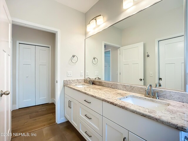 31 Lewis Blvd, Saint Augustine, FL 32084 - bathroom with double vanity, wood finished floors, baseboards, and a sink