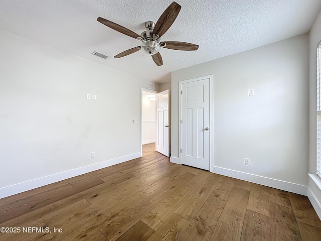31 Lewis Blvd, Saint Augustine, FL 32084 - unfurnished bedroom featuring visible vents, a textured ceiling, baseboards, and wood finished floors