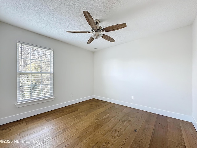 31 Lewis Blvd, Saint Augustine, FL 32084 - unfurnished room with a textured ceiling, a ceiling fan, baseboards, and dark wood-style flooring
