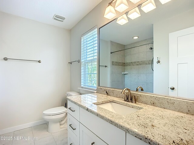 31 Lewis Blvd, Saint Augustine, FL 32084 - bathroom featuring visible vents, toilet, a tile shower, baseboards, and vanity