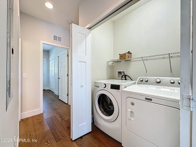 31 Lewis Blvd, Saint Augustine, FL 32084 - laundry area with visible vents, baseboards, washer and clothes dryer, laundry area, and dark wood-style floors