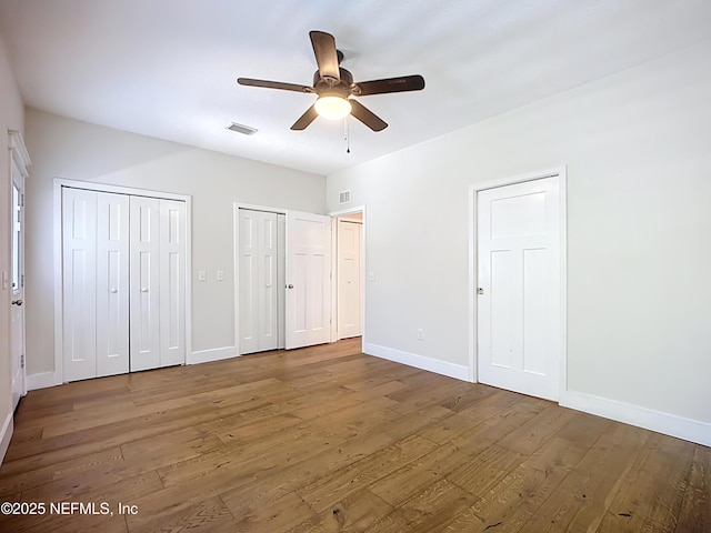 31 Lewis Blvd, Saint Augustine, FL 32084 - unfurnished bedroom featuring visible vents, two closets, baseboards, and wood finished floors