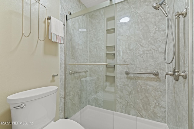 full bathroom with a shower stall and toilet