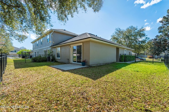 back of property with stucco siding, cooling unit, a yard, a fenced backyard, and a patio