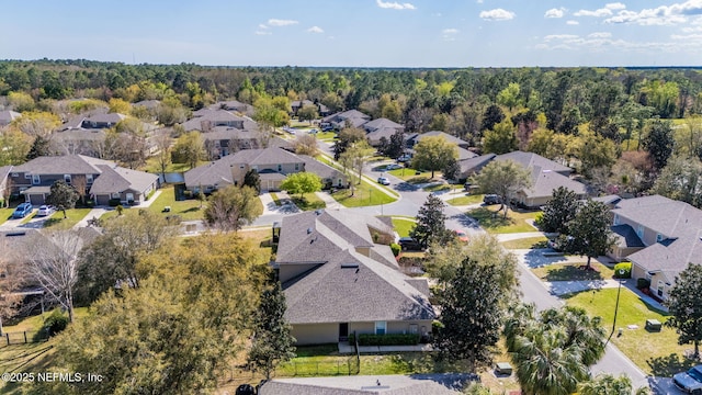 birds eye view of property featuring a residential view and a view of trees