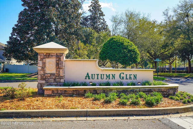 community sign featuring fence