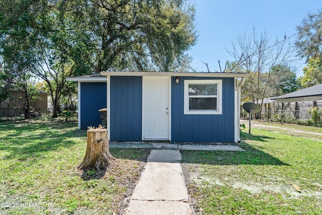 view of outbuilding with an outdoor structure and fence