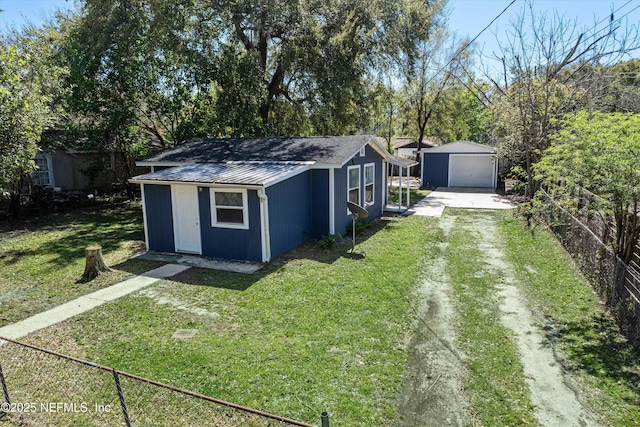 view of outdoor structure with fence, an outdoor structure, and dirt driveway