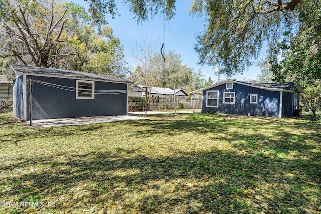 view of yard with an outdoor structure and fence