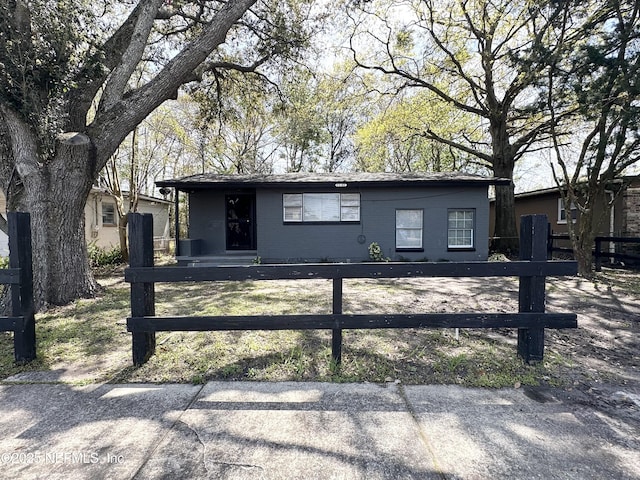 ranch-style home featuring a fenced front yard