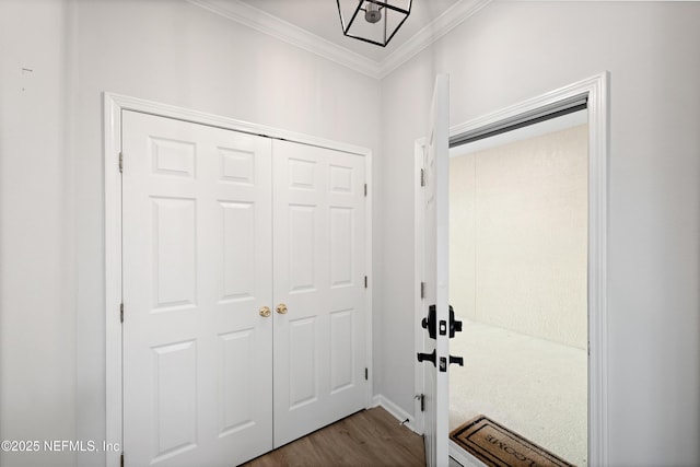 entryway featuring dark wood-style floors and ornamental molding