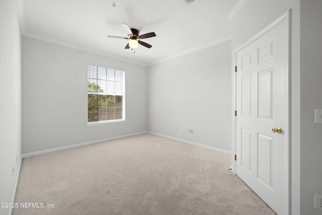 carpeted empty room with baseboards, a ceiling fan, and ornamental molding