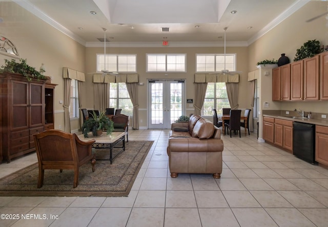 living area featuring visible vents, light tile patterned flooring, ornamental molding, french doors, and a towering ceiling