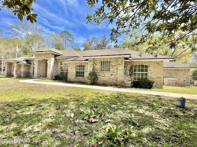 view of front of home with a front lawn and brick siding