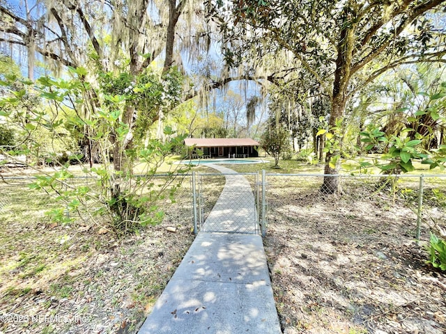 view of community featuring a gate, fence private yard, and a water view